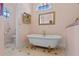 Bathroom with a clawfoot tub and decorative mirror at 800 W 2Nd Ave, Windermere, FL 34786