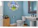 Powder room with pedestal sink and decorative mirror at 800 W 2Nd Ave, Windermere, FL 34786