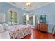 Charming bedroom with hardwood floors, arched windows, and a dresser at 800 W 2Nd Ave, Windermere, FL 34786