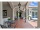 Elegant covered patio with arched entryways and terracotta tile flooring at 800 W 2Nd Ave, Windermere, FL 34786