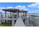 Covered boat dock with lift and seating area at 800 W 2Nd Ave, Windermere, FL 34786