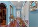 Elegant entryway with hardwood floors, wine cellar, and decorative mirror at 800 W 2Nd Ave, Windermere, FL 34786