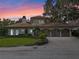 Stunning waterfront home with a beautiful facade and landscaping at 800 W 2Nd Ave, Windermere, FL 34786