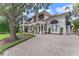 Two-story house with balconies, paver driveway, and lush landscaping at 800 W 2Nd Ave, Windermere, FL 34786