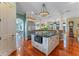 Gourmet kitchen with island, stainless steel appliances, and hardwood floors at 800 W 2Nd Ave, Windermere, FL 34786