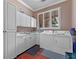 Bright laundry room with white cabinets, sink, and washer/dryer at 800 W 2Nd Ave, Windermere, FL 34786