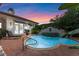 Stunning pool at dusk, featuring a water feature and terracotta tile at 800 W 2Nd Ave, Windermere, FL 34786