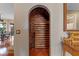 Built-in wine cellar with brick walls and wooden shelving at 800 W 2Nd Ave, Windermere, FL 34786