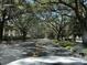 Canopied street view showing mature trees and building at 829 Camargo Way # 212, Altamonte Springs, FL 32714