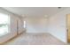 Spacious bedroom with neutral carpeting and large window at 2090 Penn Dr, Deland, FL 32724