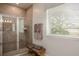 Bathroom with a large shower, tiled walls, and a window at 605 N Boundary Ave, Deland, FL 32720