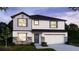 Charming two-story home with a two-car garage, manicured lawn, and modern architectural details at 605 N Boundary Ave, Deland, FL 32720