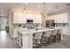 Spacious kitchen featuring white cabinets, quartz countertops, and an island with seating at 605 N Boundary Ave, Deland, FL 32720