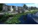 Modern apartments overlooking a tranquil pond, framed by lush greenery and a security fence at 4424 S Texas Ave, Orlando, FL 32839