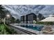 Modern apartment building with a stunning pool, lounge chairs, and tables for residents to enjoy the outdoor space at 4424 S Texas Ave, Orlando, FL 32839