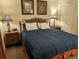 King-size bed, nightstands, and artwork in a condo bedroom at 13427 Blue Heron Beach Dr # 702, Orlando, FL 32821