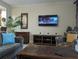 Living room with large TV, comfortable seating and a coffee table at 13427 Blue Heron Beach Dr # 702, Orlando, FL 32821