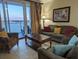 Living room with water views, comfy seating, and a coffee table at 13427 Blue Heron Beach Dr # 702, Orlando, FL 32821