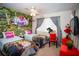 Themed bedroom with two twin beds and whimsical decor, including an Alice in Wonderland-themed mural at 3001 Sunset Vista Blvd, Kissimmee, FL 34747