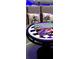 Close-up of a game table with Monopoly, Magnetic Games, and Star Wars-themed pillows for a fun recreational space at 3001 Sunset Vista Blvd, Kissimmee, FL 34747