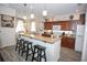 Spacious kitchen featuring granite counters, stainless steel appliances, and breakfast bar at 3001 Sunset Vista Blvd, Kissimmee, FL 34747