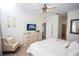 Cozy bedroom featuring a ceiling fan, dresser, and neutral tones at 3001 Sunset Vista Blvd, Kissimmee, FL 34747