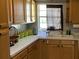 Cozy kitchen featuring wood cabinets and a corner sink at 241 N Hill Ave, Deland, FL 32724