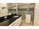 Modern bathroom with a granite countertop vanity and glass-enclosed walk-in shower at 1507 Tranquil Ave, Clermont, FL 34714