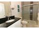 Modern bathroom with granite countertops, sliding glass door shower, and updated fixtures at 1507 Tranquil Ave, Clermont, FL 34714