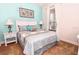 Comfortable bedroom featuring a queen-size bed, side tables with lamps, and bright, natural light at 1507 Tranquil Ave, Clermont, FL 34714