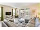 Cozy living room with a comfortable sectional sofa, a sliding door view, and modern decor at 1507 Tranquil Ave, Clermont, FL 34714