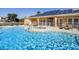 Community pool with lounge chairs and solar panels above an adjacent building at 1507 Tranquil Ave, Clermont, FL 34714