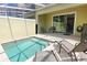 Relaxing outdoor pool with a tiled patio, lounge chairs, and privacy at 1507 Tranquil Ave, Clermont, FL 34714