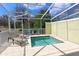 Private screened-in pool with tiled surround and lounge chairs at 1507 Tranquil Ave, Clermont, FL 34714