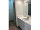 Bathroom with white vanity, and a large mirror with a tile countertop at 6254 Masters Blvd # D106, Orlando, FL 32819