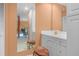 Bathroom featuring a vanity with stool seating, large mirror and the view of Primary bedroom at 6254 Masters Blvd # D106, Orlando, FL 32819