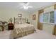Bedroom with green walls, white carpet, queen bed and a ceiling fan provides a relaxing and comfortable space at 6254 Masters Blvd # D106, Orlando, FL 32819
