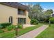 Two-story home with an outdoor patio and beautiful landscaping creating a perfect outdoor living space at 6254 Masters Blvd # D106, Orlando, FL 32819