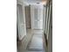 Hallway features tile flooring, natural light and offers access to rooms with bright, louvered doors at 6254 Masters Blvd # D106, Orlando, FL 32819