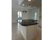 Kitchen island with a black countertop and classic chandelier, offering a stylish focal point at 6254 Masters Blvd # D106, Orlando, FL 32819