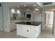 Kitchen with sleek white cabinetry, a central island, and modern appliances for a functional, stylish space at 6254 Masters Blvd # D106, Orlando, FL 32819