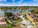 Aerial shot of the property showing well-manicured lawn, gated entrance, and stunning lake views at 10843 Lakeshore Dr, Clermont, FL 34711
