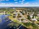 Wonderful aerial view of lakeside homes featuring private docks and well-manicured lawns in a quiet, peaceful neighborhood setting at 10843 Lakeshore Dr, Clermont, FL 34711