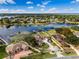Panoramic aerial view showcasing the lakefront property with lush landscaping and private dock access at 10843 Lakeshore Dr, Clermont, FL 34711