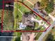 Aerial view of a lakeside home with a large backyard, swimming pool, and a private dock enclosed in a red line at 10843 Lakeshore Dr, Clermont, FL 34711