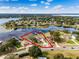Aerial view of a lakeside home with a large backyard, swimming pool, and a private dock, enclosed in a red line at 10843 Lakeshore Dr, Clermont, FL 34711