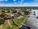 Aerial view of the backyard with a pool and waterfront dock and views of a serene lake at 10843 Lakeshore Dr, Clermont, FL 34711