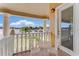 Cozy balcony with a small table, chairs, and a serene lake view at 10843 Lakeshore Dr, Clermont, FL 34711