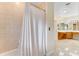 Bright bathroom featuring tiled walls, a bathtub with shower, and a vanity with ample counter space at 10843 Lakeshore Dr, Clermont, FL 34711