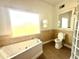 Bathroom features a large soaking tub and separate glass shower at 10843 Lakeshore Dr, Clermont, FL 34711